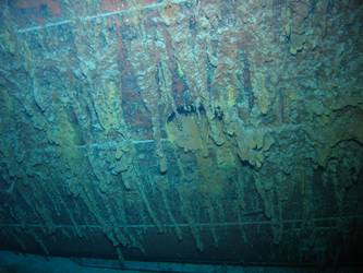 Port side of hull resting on seabed.